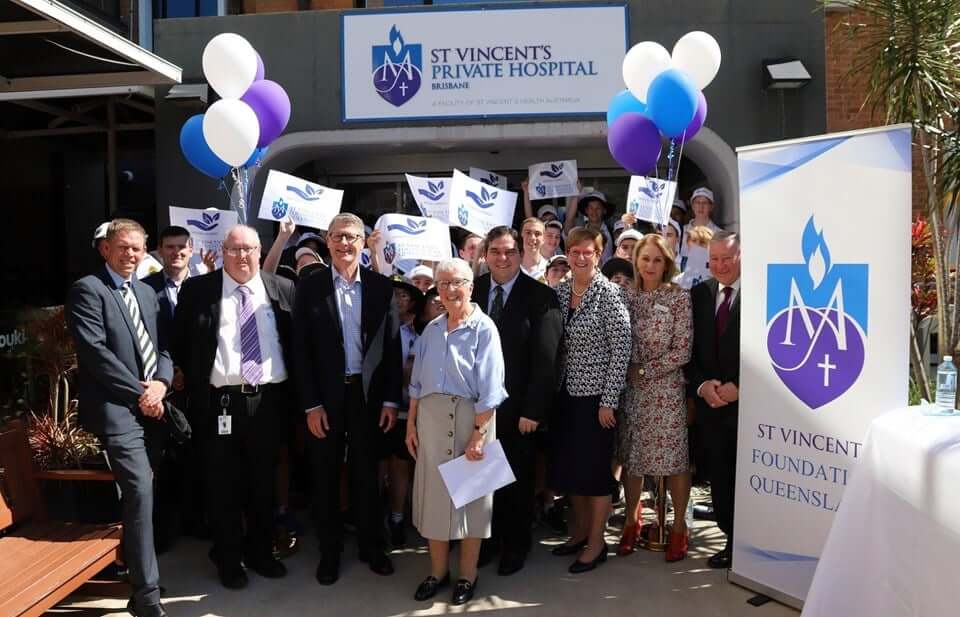Supporters holding balloons and signs at a St Vincent's Foundation community fundraising event